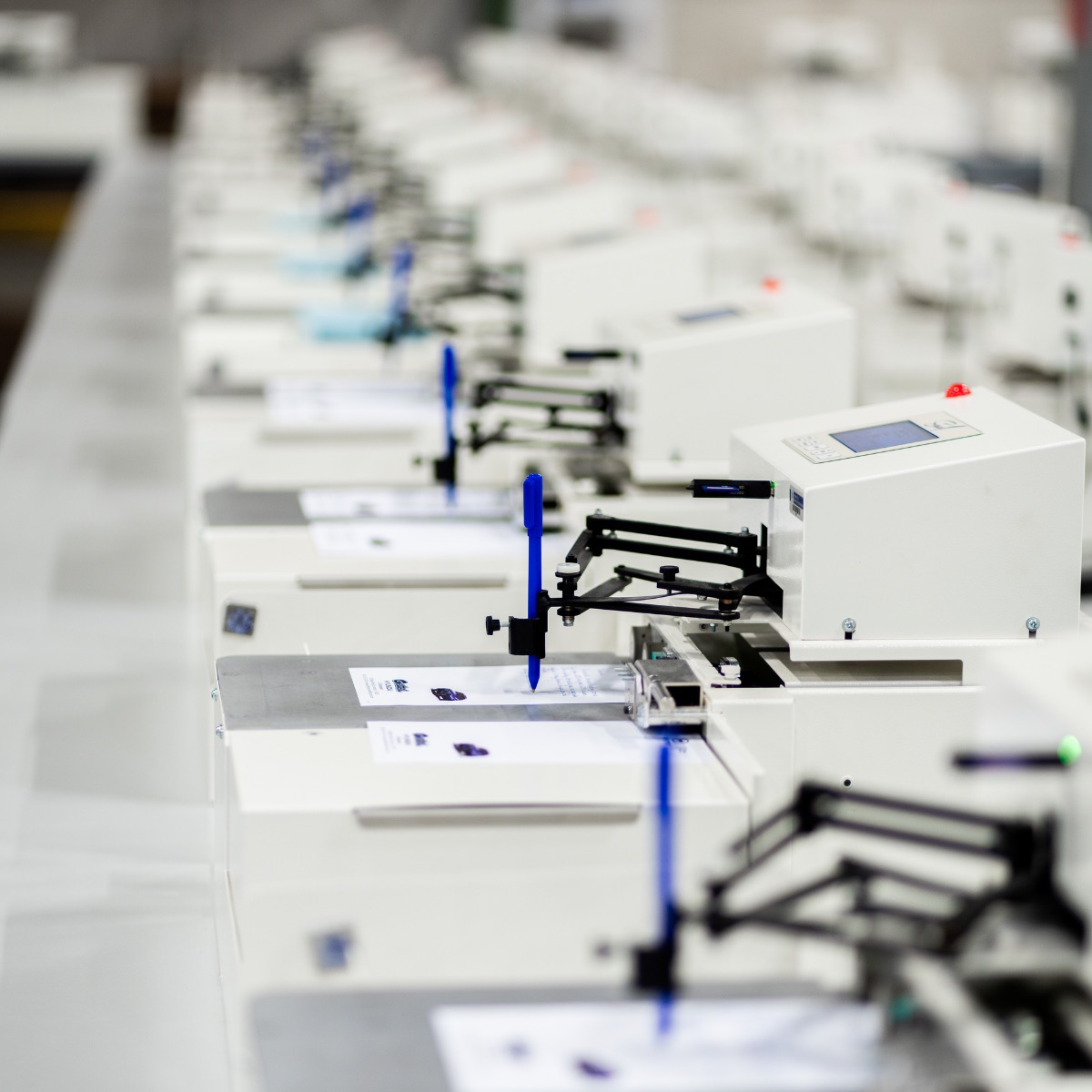 A row of UniProd handwriting machines at the Pen Point Technologies facility